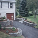 Curved wallstone planters surrounding a driveway